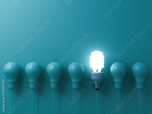 One hanging eco energy saving light bulb glowing and standing out from unlit incandescent bulbs on green pastel color wall background  leadership and different creative idea concepts 3D rendering photo