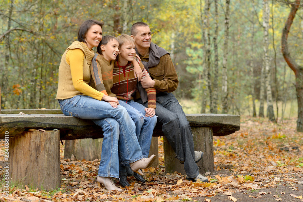 Portrait of family of four in park