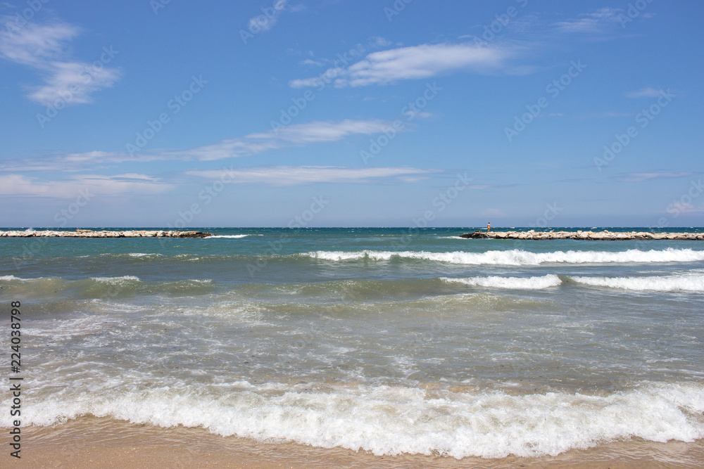 Mooring coast with waves on sunny day. Seascape background. Mooring bay concept. Travel and tourism concept. 