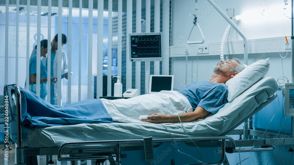 In the Hospital Sick Man Rests, Lying on the Bed. Recovering Man Sleeping in the Modern Hospital