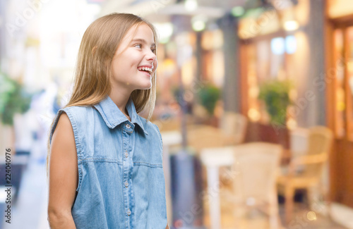 Young beautiful girl over isolated background looking away to side with smile on face, natural expression. Laughing confident. Free Download Young beautiful girl over isolated background looking away to side with smile on face, natural expression. Laughing confident. - GFXLoad