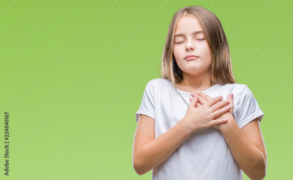 Young beautiful girl over isolated background smiling with hands on chest with closed eyes and grateful gesture on face. Health concept. Young beautiful girl over isolated background smiling with hands on chest with closed eyes and grateful gesture on face. Health concept.