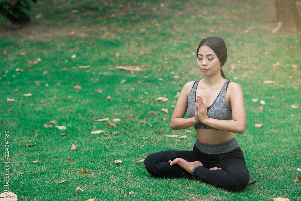 Slim girl play yoga on the lawn at the park,relax in nuture,Asian Girls love health practicing yoga Slim girl play yoga on the lawn at the park,relax in nuture,Asian Girls love health practicing yoga