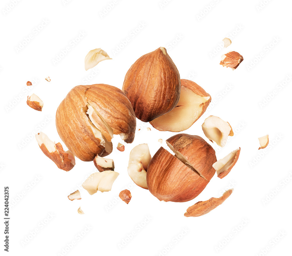 Hazelnuts is torn to pieces closeup, isolated on white background