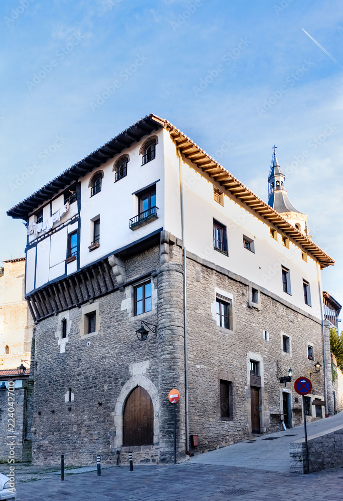 Typical house in the north of Spain in the city of Vitoria with stone facade and top painted white, located in the old part of the city