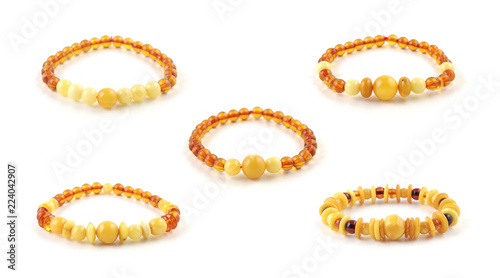 Five different beaded amber bracelet models isolated on white background