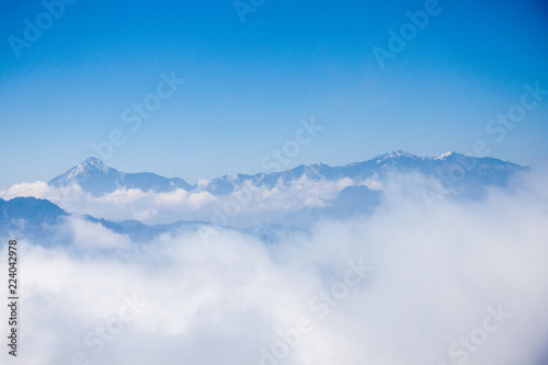 Blue sky and mountains peaks on the cloud