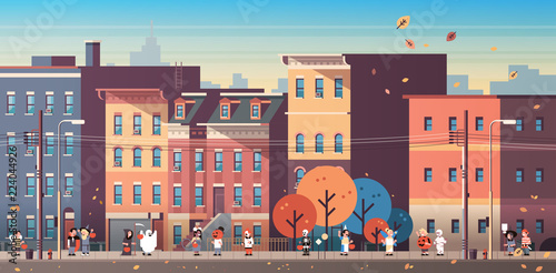 kids wearing monsters costumes walking town holiday concept cityscape background tricks or treat happy halloween cartoon character full length horizontal banner flat vector illustration
