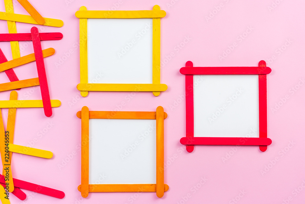blank photo frame made of color popsicle wood sticks on pink background blank photo frame made of color popsicle wood sticks on pink background