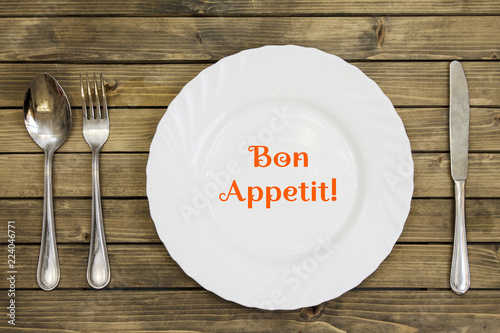 Empty dish and cutlery on wooden background closeup photo