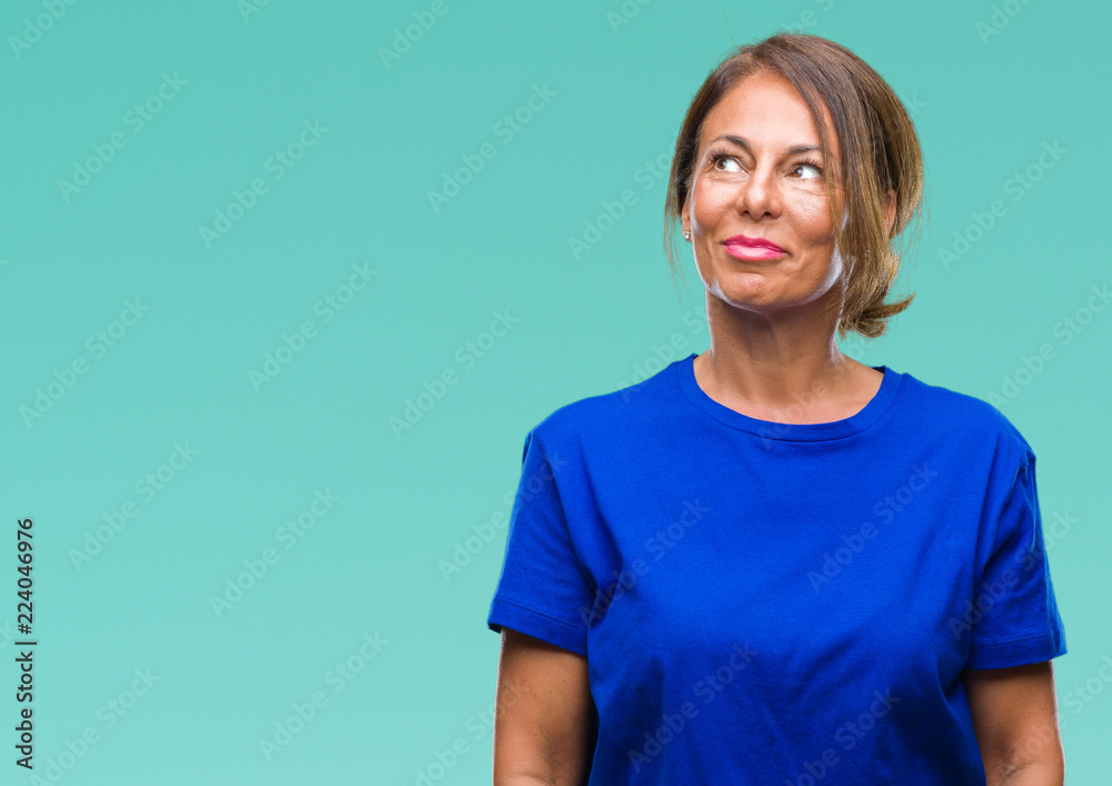 Middle age senior hispanic woman over isolated background smiling looking side and staring away thinking. Middle age senior hispanic woman over isolated background smiling looking side and staring away thinking.