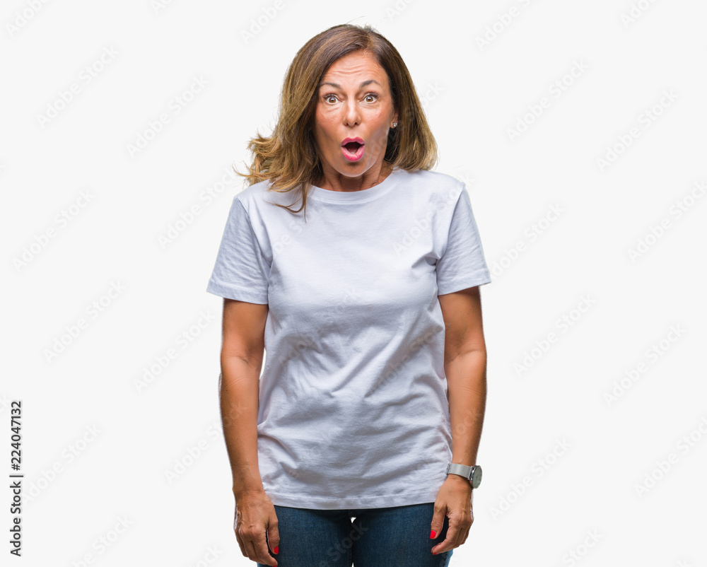 Obraz premium Middle age senior hispanic woman over isolated background afraid and shocked with surprise expression, fear and excited face.