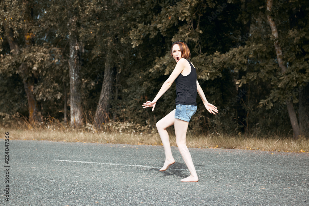 young girl walking barefoot on the road, the concept of summer and travel
