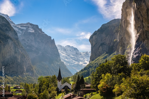 Sun shining on the Staubbach fall (Berner Oberland, Switzerland). Lauterbrunnen lies at the bottom of the Lauterbrunnen valley. It is one of the deepest in the Alpine chain.