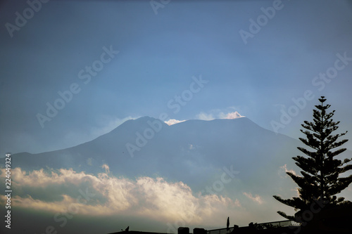 Etna volcano with clouds surrounding the mountain top