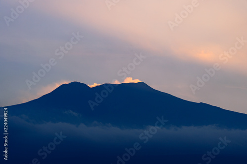Etna volcano with clouds surrounding the mountain top