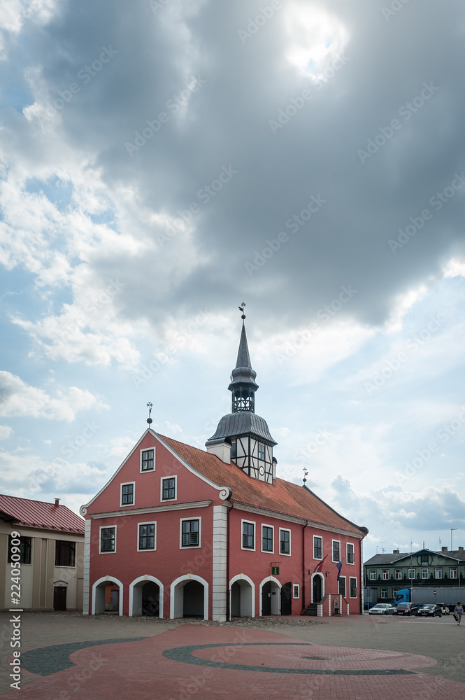 View to the Bauska town hall and market square in historical center with cloudy sky. Bauska, Latvia.