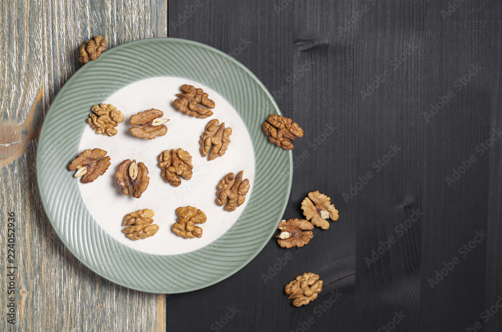 Few walnuts in a plate and near Few walnuts in a plate and near