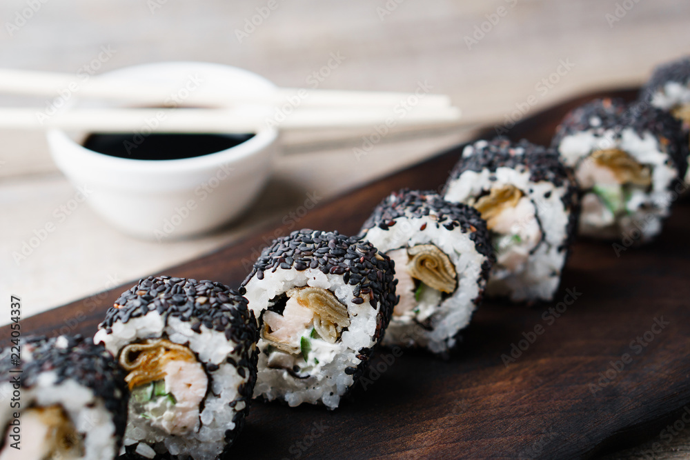 Restaurant menu, Japanese food art. Appetizing sushi rolls served on wooden tray Restaurant menu, Japanese food art. Appetizing sushi rolls served on wooden tray