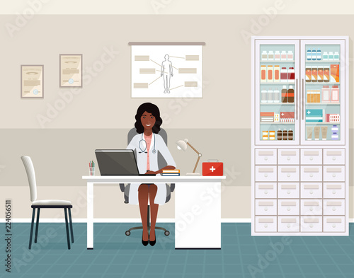 Afro american woman doctor in uniform sitting in doctor's office. Medical consulting room interior with table