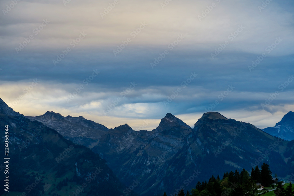 Alpine scene in the Swiss mountains: Sunset and storm clouds