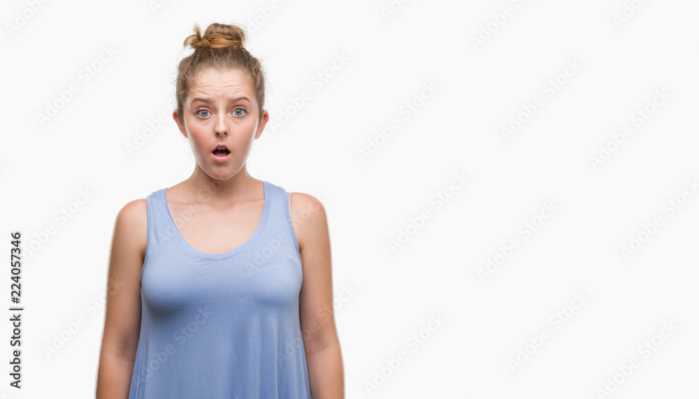 Young blonde woman afraid and shocked with surprise expression, fear and excited face. Young blonde woman afraid and shocked with surprise expression, fear and excited face.