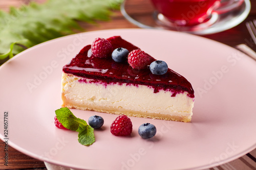 Cheesecake with berries on wooden background