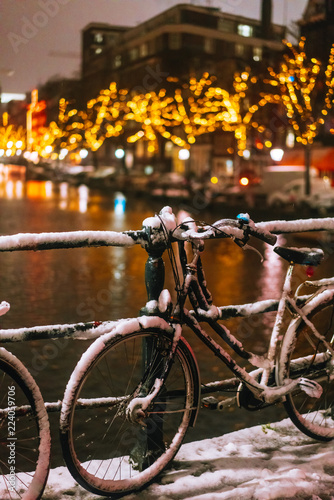 Bicycles Parked Along a Bridge Over the Canals of Amsterdam