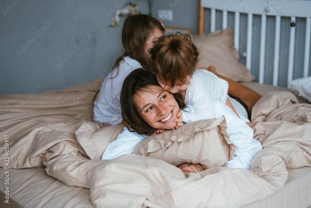 Mom and her two little cute daughters are having fun Mom and her two little cute daughters are having fun