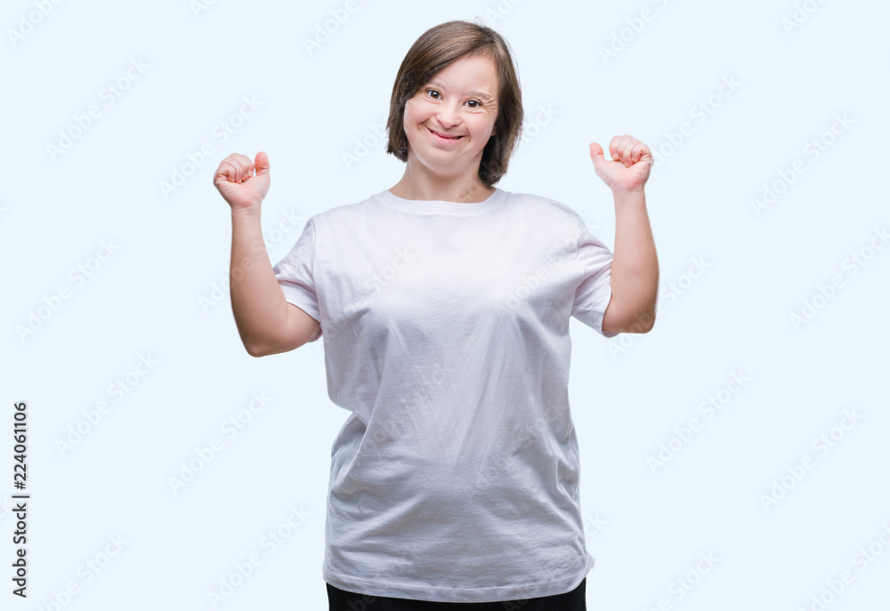 Young adult woman with down syndrome over isolated background excited for success with arms raised celebrating victory smiling. Winner concept. Young adult woman with down syndrome over isolated background excited for success with arms raised celebrating victory smiling. Winner concept.