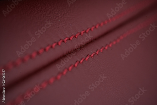 Detailed image of a car leather pleats stitch work. © xpabli
