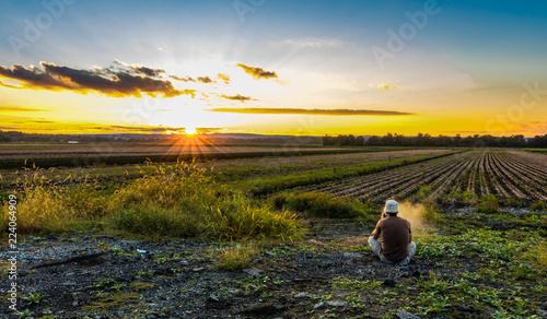Watching the sunset, vaping, in late summer over farmlands in the black dirt region of Pine Island, New York