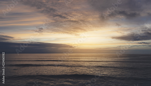 Sunlight sunset on horizon ocean on background seascape rays sunrise. Relax view waves sea on evening sand beach, sun light flare nature evening outdoor vacation concept, copy space for text.