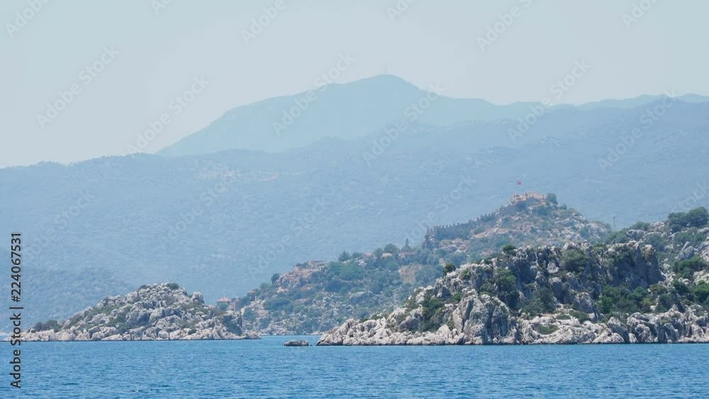 Ancient village of Simena, near Kekova island. Antalya province, Turkey. Shooting from moving yacht. Ancient village of Simena, near Kekova island. Antalya province, Turkey. Shooting from moving yacht.