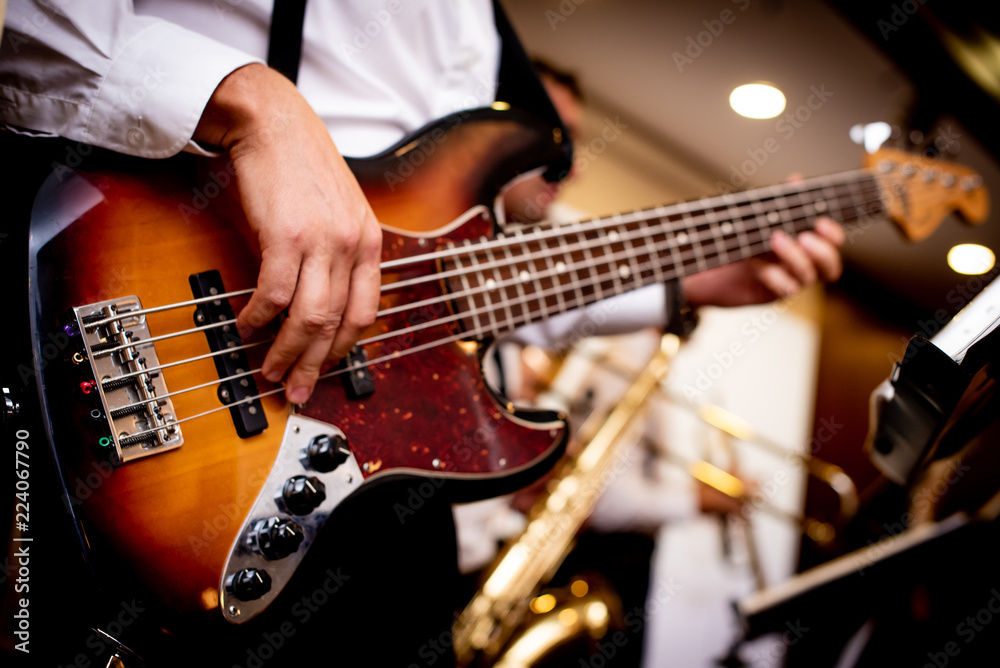 Fototapeta premium electronic guitar in the hands of a man dressed in a white shirt
