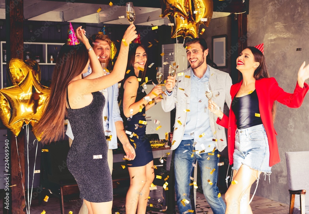 Super party with best friends. A company of very positive friends have fun in confetti at a party.