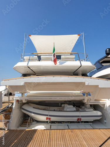 tender housed in the aft garage of a luxurious yacht anchored in the harbour