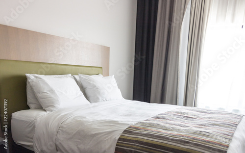 Fototapeta Naklejka Na Ścianę i Meble -  Elegant hotel bedroom, copy space image