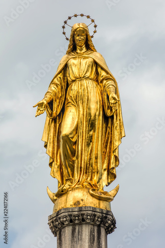 Gilded statue of Maria Immaculata on a sphere with snake and a crescent moon, sculpted by Anton Dominik Ritter von Fernkorn in 1870, placed on top of a column near Zagreb Cathedral in Zagreb, Croatia photo