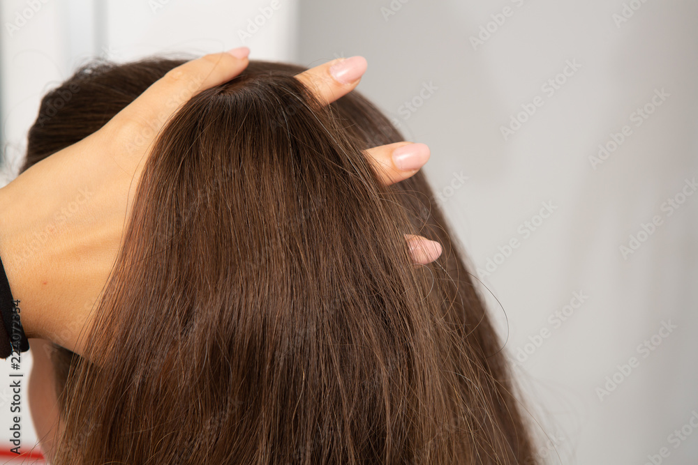 Concept of female vanity, woman with hand in her hair Concept of female vanity, woman with hand in her hair