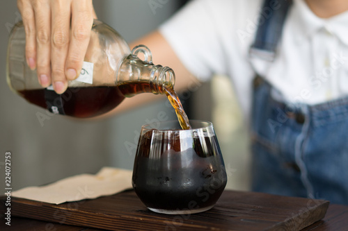 Women are pouring cold brewed coffee.