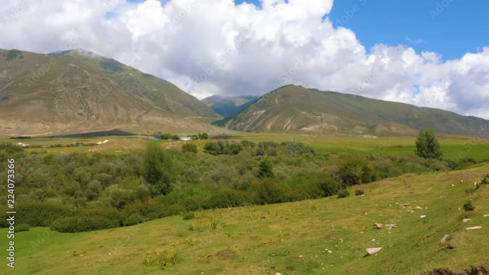 Panoramic view of summer landscape with mountains and meadow Panoramic view of summer landscape with mountains and meadow