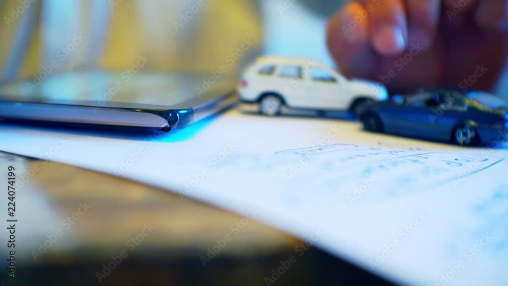 businessman working with paper document.on the table is a sheet of paper, an electronic gadget and a small car model.Shallow depth of field.Business concept.Sale, purchase or insurance of a car.
businessman working with paper document.on the table is a sheet of paper, an electronic gadget and a small car model.Shallow depth of field.Business concept.Sale, purchase or insurance of a car.