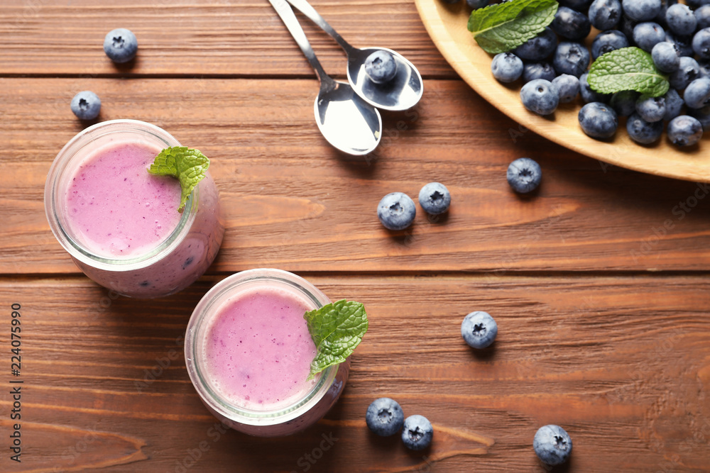 Flat lay composition with blueberry smoothie on wooden table Flat lay composition with blueberry smoothie on wooden table