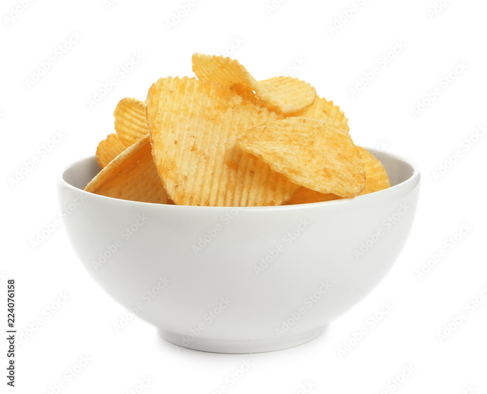 Bowl of tasty ridged potato chips on white background