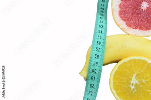 orange, grapefruit and banana on a white background with place for inscription, a symbol of diet and healthy eating