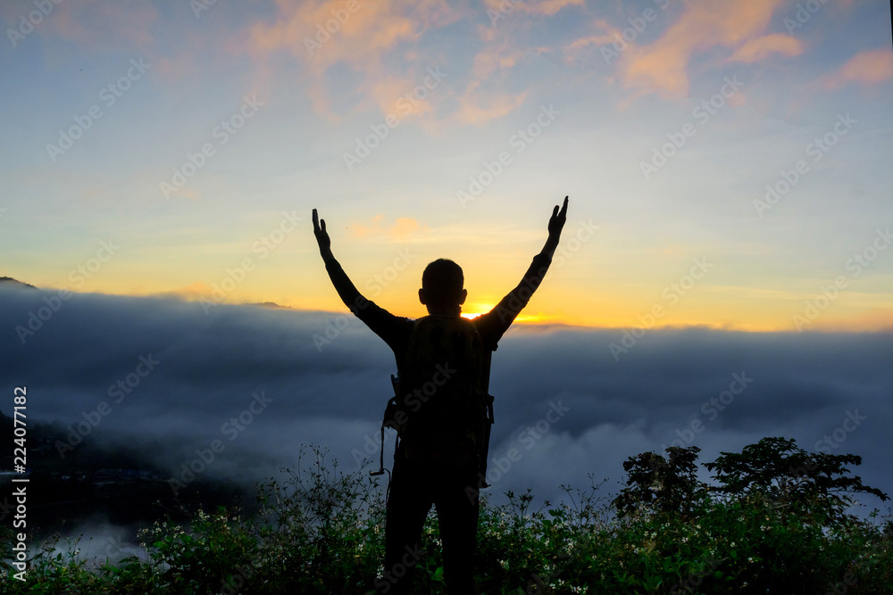 Silhouette of man standing with near a camping tent at sunrise ,success concept. Silhouette of man standing with near a camping tent at sunrise ,success concept.