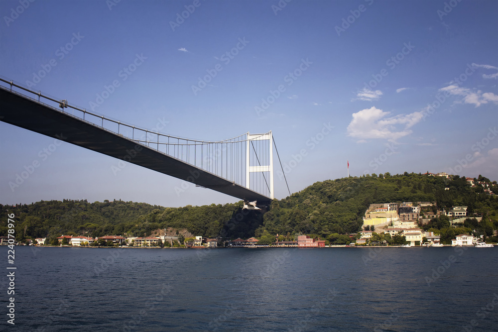 View of FSM bridge, Bosphorus and buildings on Aisan side of Istanbul. It is a sunny summer day.