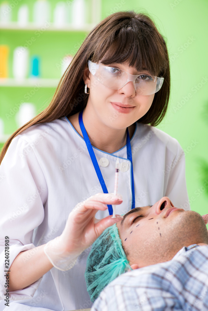 Plastic surgeon preparing for operation on man face Plastic surgeon preparing for operation on man face