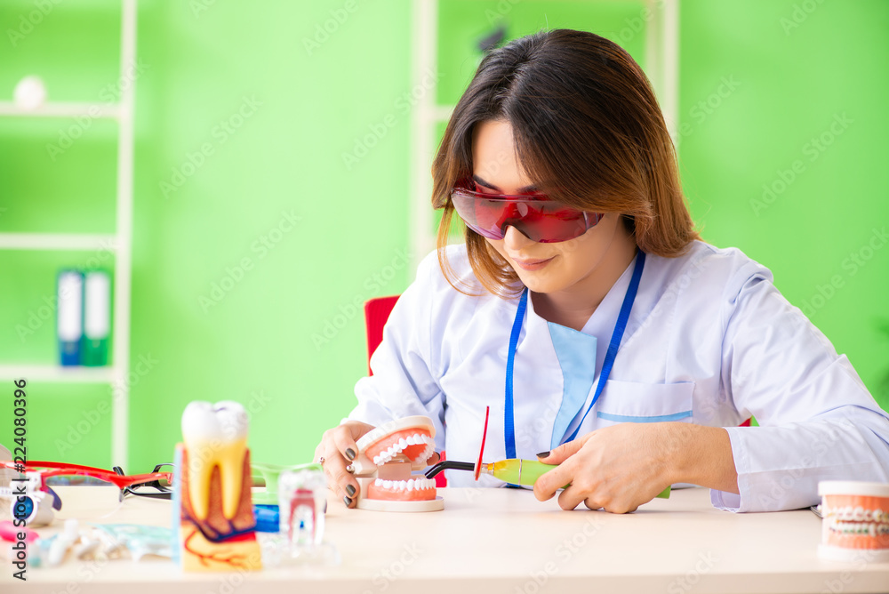 Woman dentist working on teeth implant Woman dentist working on teeth implant